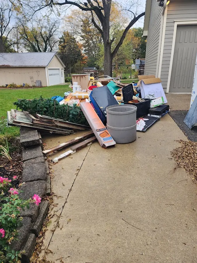 Dumpster being loaded with debris for Commercial Dumpster Rental in West Haven
